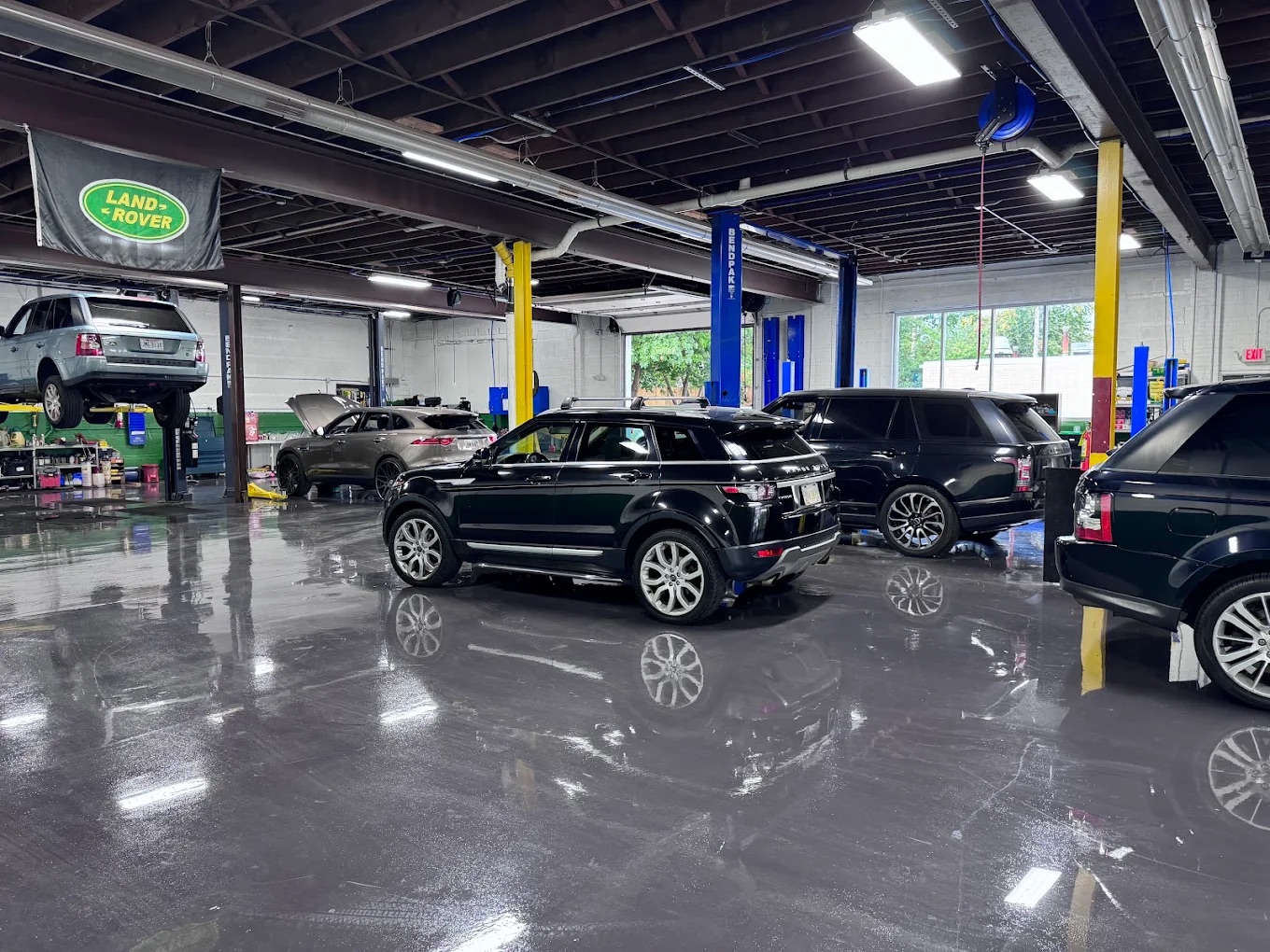 Westend Rover + Jag service floor with Land Rovers and a Jaguar on the lifts